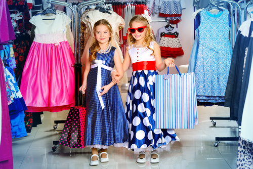 Two stylishly dressed little girls in the mall Stock Photo