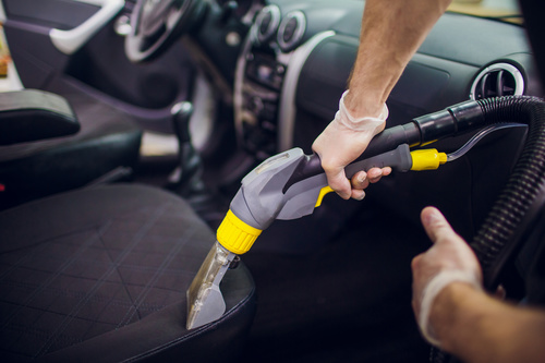 Use vacuum cleaner to clean the interior of the car Stock Photo
