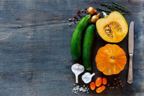 Vegetables and cut pumpkin on the desktop Stock Photo