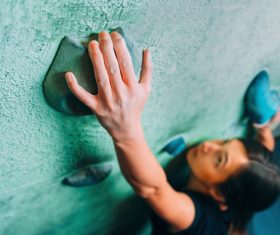 Woman indoor rock climbing Stock Photo 01