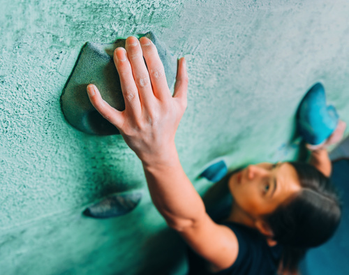 Woman indoor rock climbing Stock Photo 01