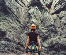 Woman preparing for rock climbing Stock Photo