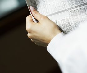 Woman reading newspaper Stock Photo