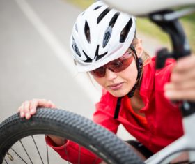 Woman resting on bicycle Stock Photo