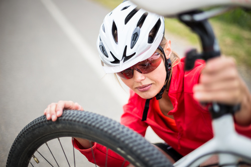 Woman resting on bicycle Stock Photo