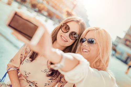 Woman using cell phone selfie Stock Photo