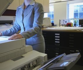 Woman using copier Stock Photo