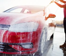 Woman washing car Stock Photo
