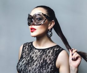 Woman wearing black butterfly mask Stock Photo 01