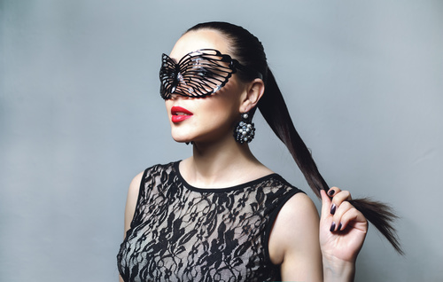 Woman wearing black butterfly mask Stock Photo 01