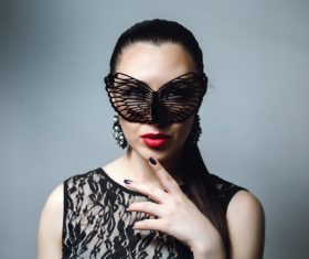 Woman wearing black butterfly mask Stock Photo 02