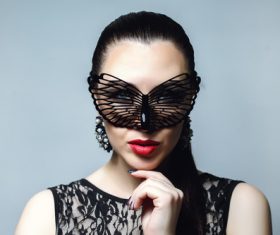 Woman wearing black butterfly mask Stock Photo 03