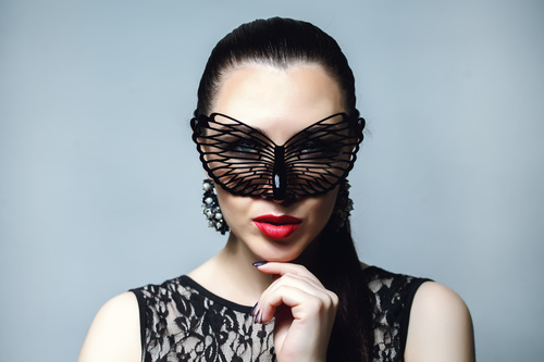 Woman wearing black butterfly mask Stock Photo 03