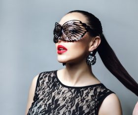 Woman wearing black butterfly mask Stock Photo 04