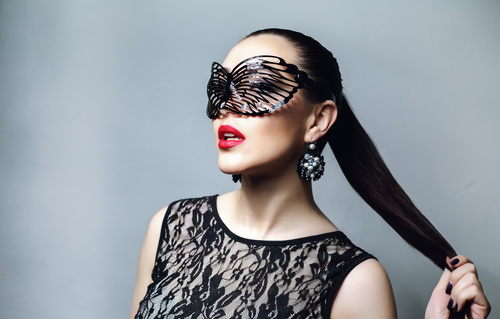 Woman wearing black butterfly mask Stock Photo 04