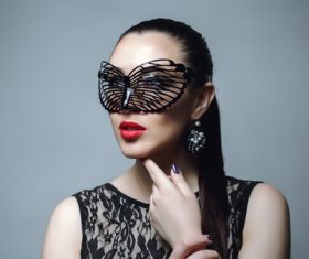 Woman wearing black butterfly mask Stock Photo 05