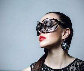 Woman wearing black butterfly mask Stock Photo 06