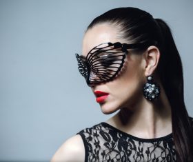 Woman wearing black butterfly mask Stock Photo 07