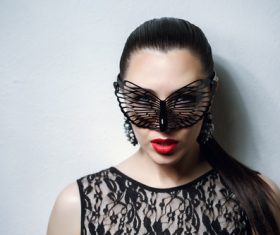Woman wearing black butterfly mask Stock Photo 13