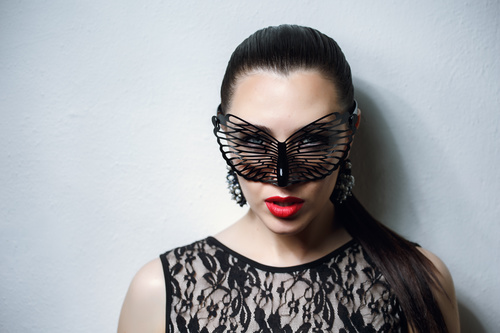Woman wearing black butterfly mask Stock Photo 13