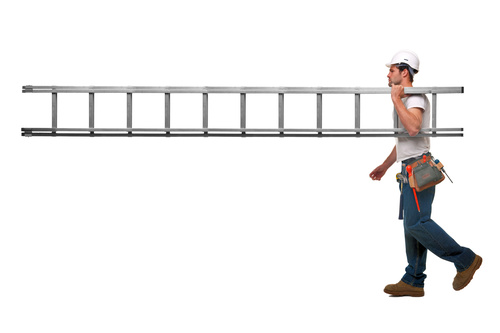 Workers carrying ladder Stock Photo