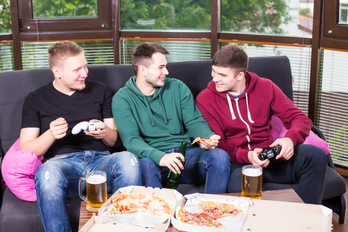Young friends at party playing games Stock Photo