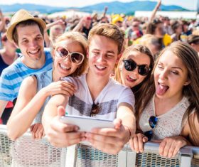Young friends who use smartphones selfie Stock Photo