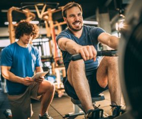 Young man doing exercise in gym Stock Photo