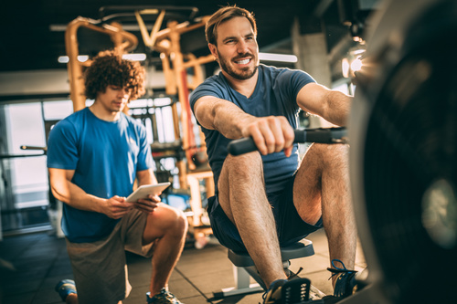Young man doing exercise in gym Stock Photo