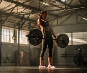 Young woman lifting weights for fitness Stock Photo