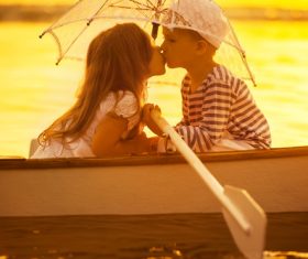 little boy boating on the lake with little girl Stock Photo 01