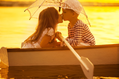little boy boating on the lake with little girl Stock Photo 01