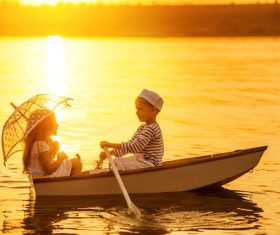 little boy boating on the lake with little girl Stock Photo 02