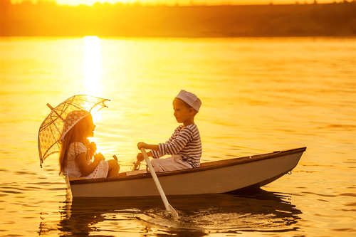 little boy boating on the lake with little girl Stock Photo 02