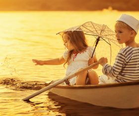 little boy boating on the lake with little girl Stock Photo 03