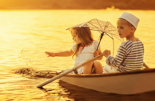 little boy boating on the lake with little girl Stock Photo 03