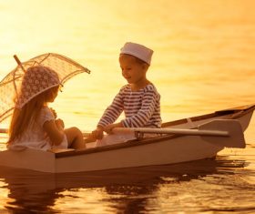 little boy boating on the lake with little girl Stock Photo 04