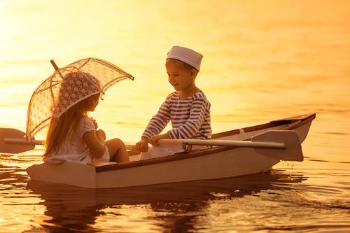 little boy boating on the lake with little girl Stock Photo 04