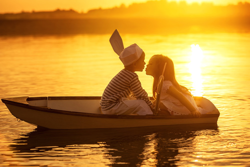 little boy boating on the lake with little girl Stock Photo 05