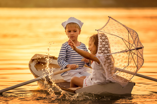 little boy boating on the lake with little girl Stock Photo 06