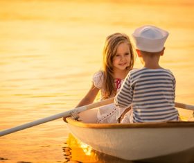 little boy boating on the lake with little girl Stock Photo 08