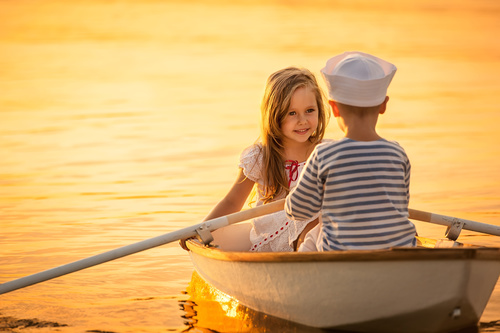little boy boating on the lake with little girl Stock Photo 08