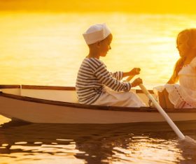 little boy boating on the lake with little girl Stock Photo 09