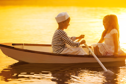 little boy boating on the lake with little girl Stock Photo 09