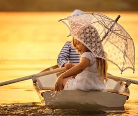 little boy boating on the lake with little girl Stock Photo 10