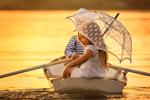little boy boating on the lake with little girl Stock Photo 10
