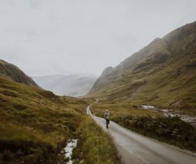 person walking mountain road Stock Photo