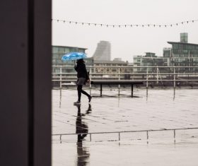 woman walking under rainy weather Stock Photo