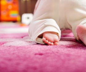 Baby crawling on the carpet Stock Photo