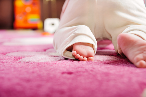Baby crawling on the carpet Stock Photo